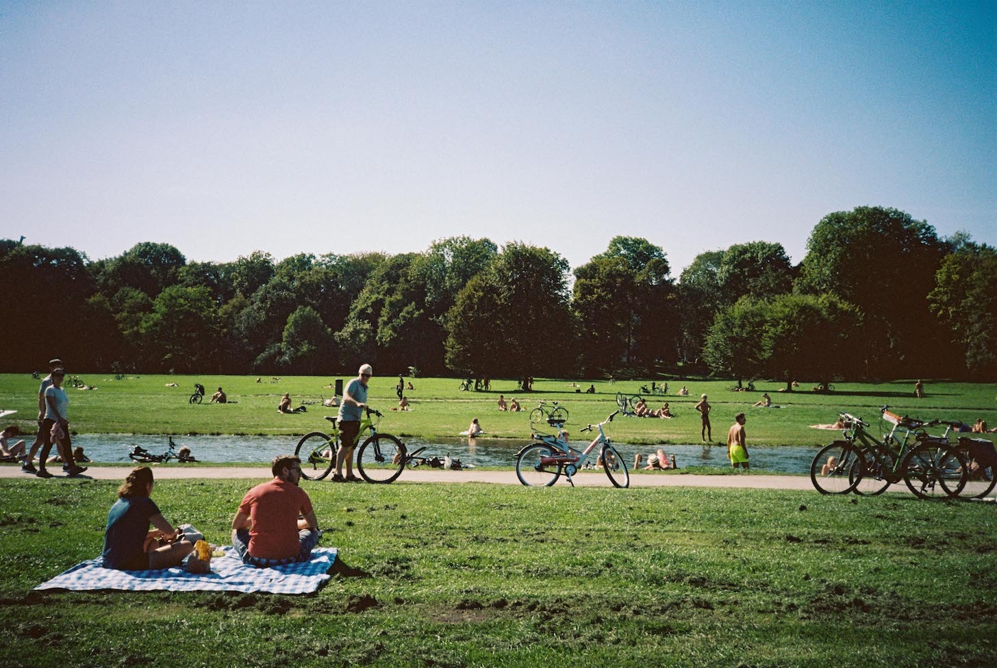 Munich residents relax by a river in the English Garden, Europe's largest city park.