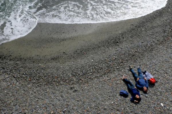 Two people relax in the Bay of Naples, Italy.